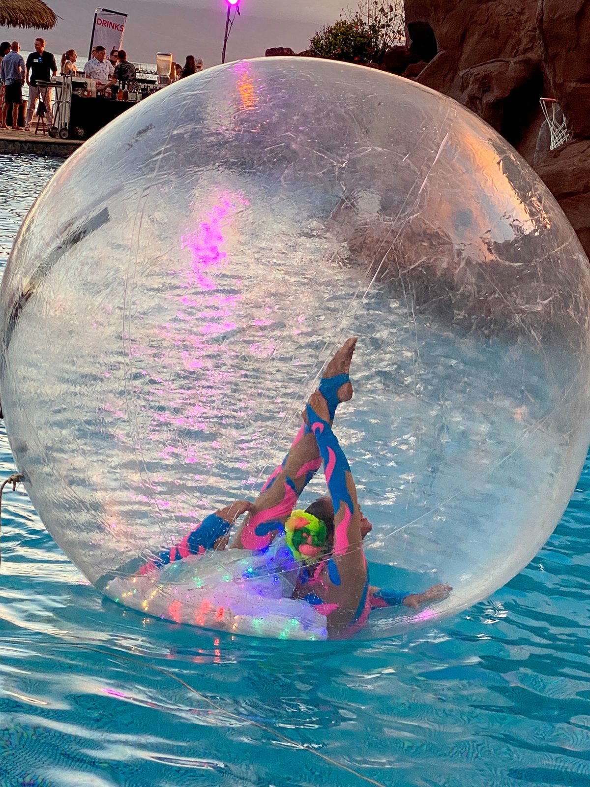 Contortion inside a giant bubble floating on a pool