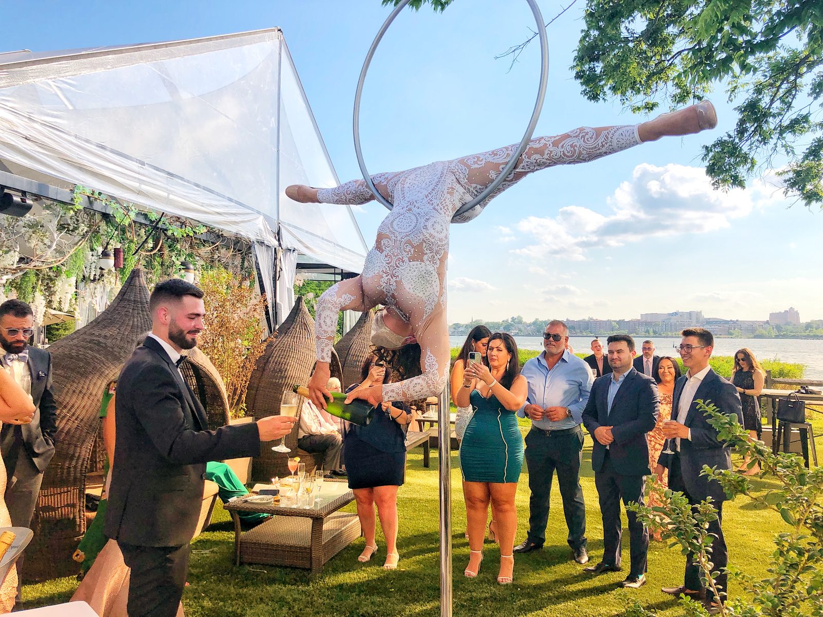 Aerial champagne pour at an outdoor wedding