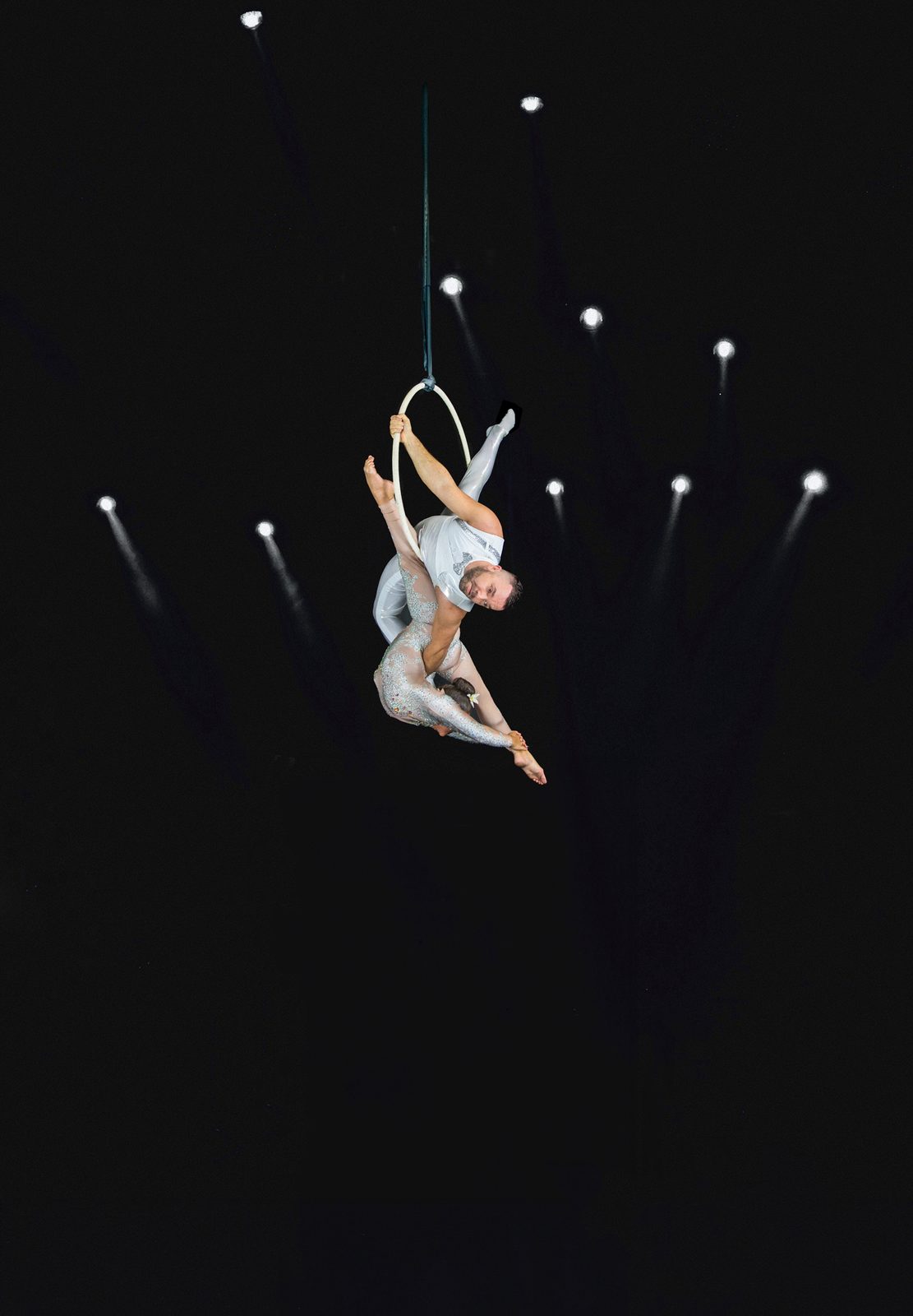 Two aerialists performing together on one hoop
