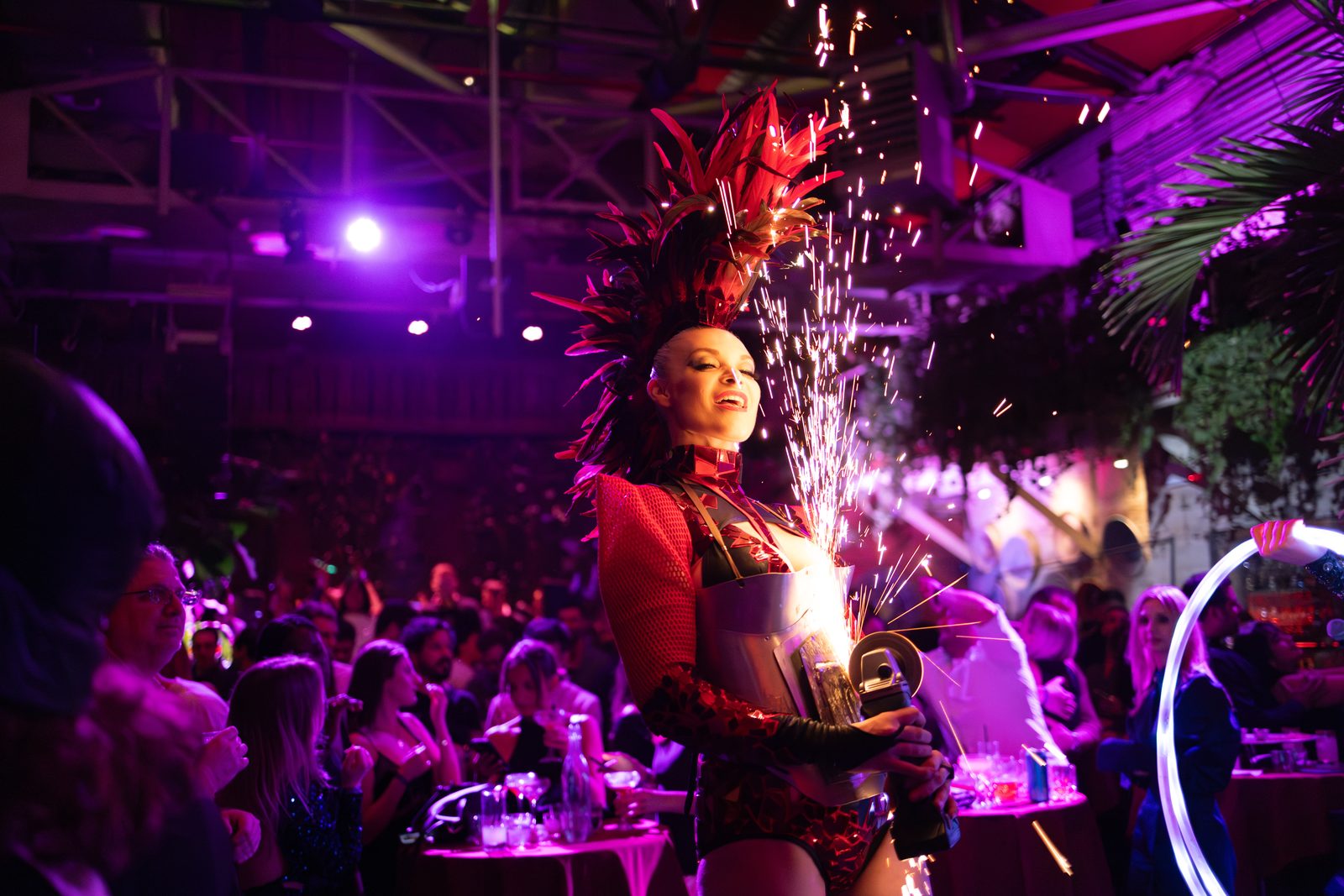 Angle grinder performer sending sparks into the air above a crowd