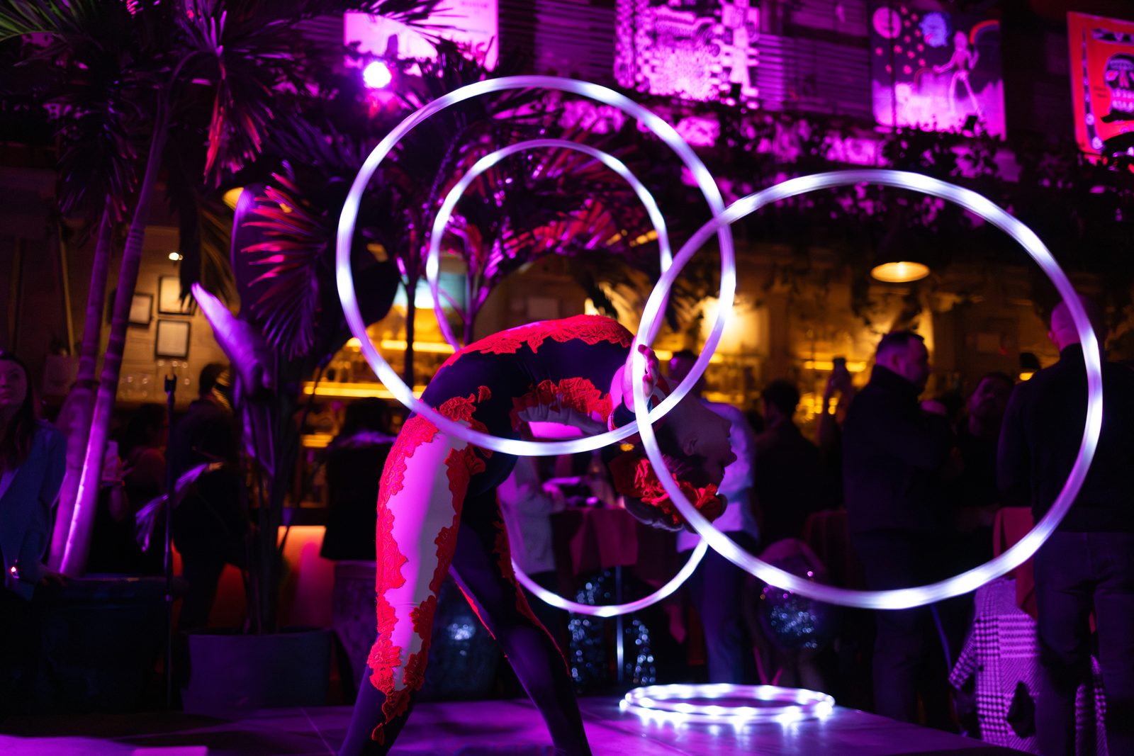 Multi-hoop performance with rings of light in a dark venue