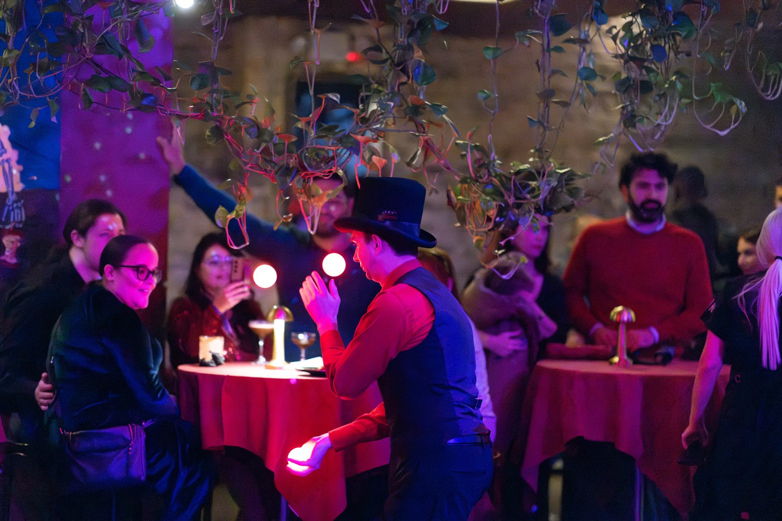 Juggler entertaining guests at a dim cocktail event